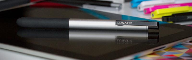 LunaTik Touch Pen on top of an iPad 3rd generation with colored markers on a table
