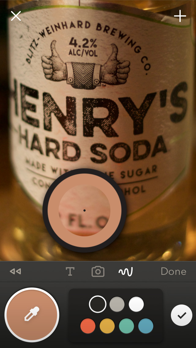 Paper app sampling a brown color from a photograph of a bottle of hard soda