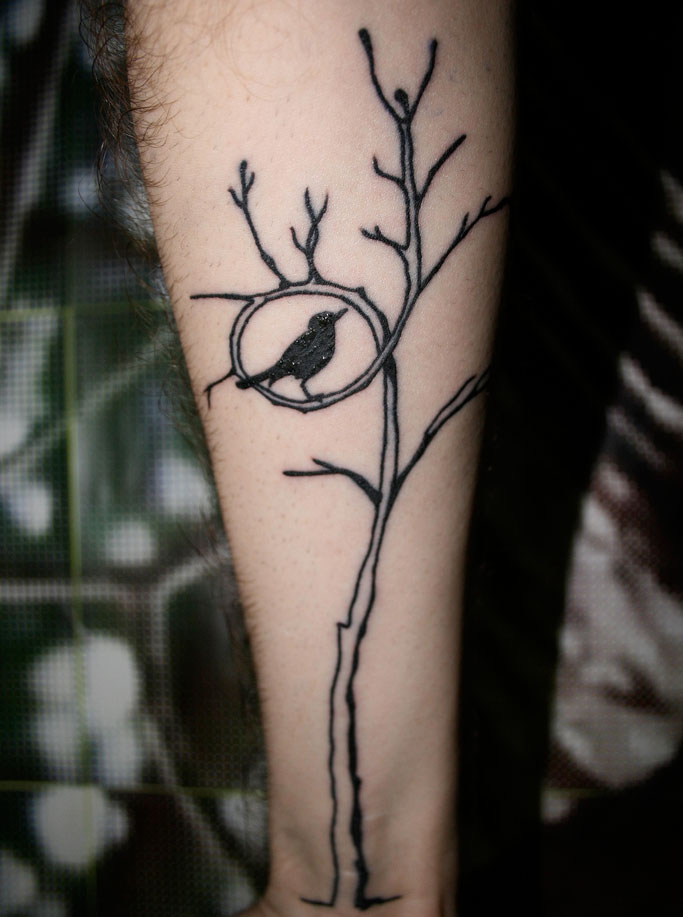 Michael’s bird in a tree forearm tattoo