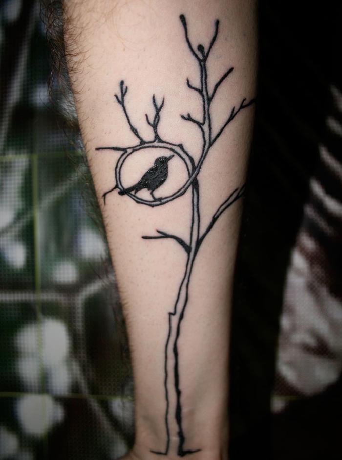 Michaels bird in a tree forearm tattoo