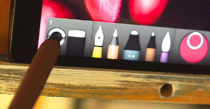 Wooden Pencil stylus touching the sync button in Papers tool tray on iPad.